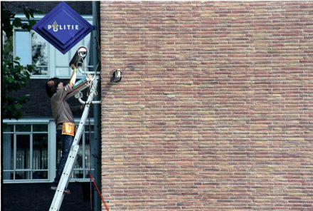 Jill Magid, Rhinestoning Headquarters. System Azure Public performance and permanent installation. Rhinestone encrusted surveillance cameras, posters. Police Headquarters, Amsterdam. 2002