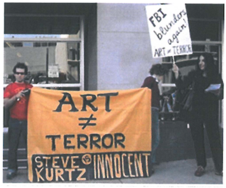 Protesters show support for Steve Kurtz, arrested on bioterrorism charges because of his artistic practice involving growing materials in petri dishes, 2004.